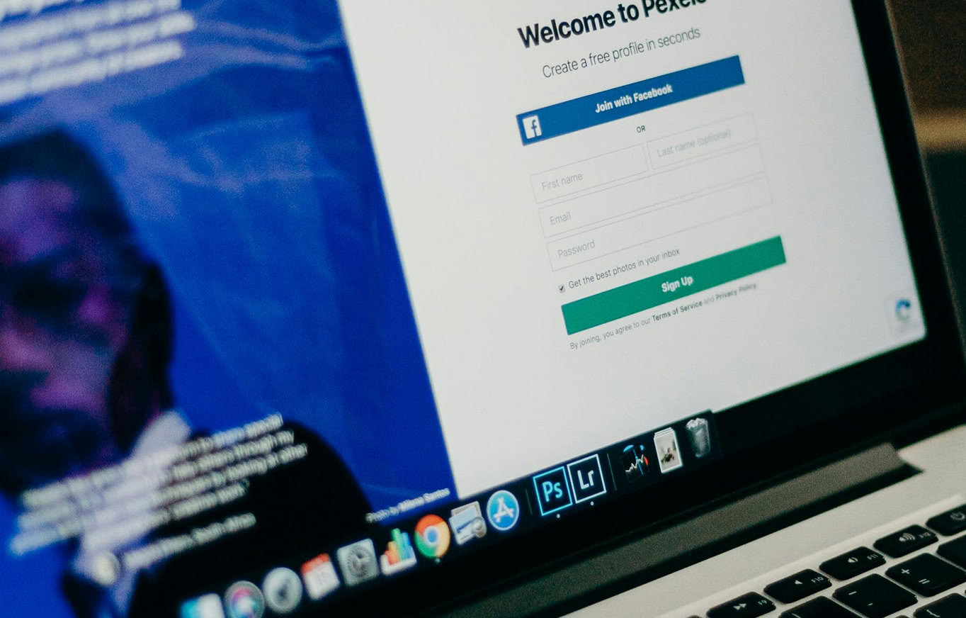 Close-up view of a laptop displaying a sign-up page for an online platform.